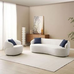 a living room with two white couches and a rug