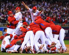 a group of baseball players standing on top of each other