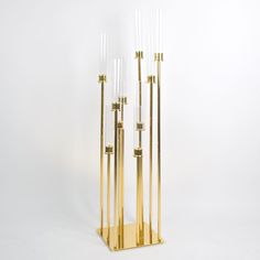 three tall brass and glass candlesticks on a white background