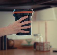 a person's hand is holding a coffee cup