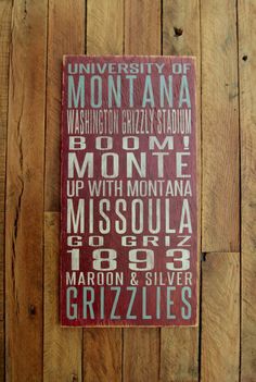 a sign on the side of a wooden wall that reads university of montana, washington crazy stadium