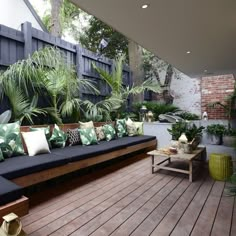 an outdoor living area with lots of plants