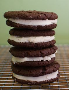 a stack of cookies sitting on top of a cooling rack covered in frosting and marshmallows