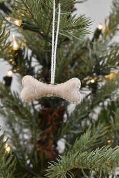 a dog bone ornament hanging from a christmas tree