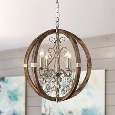 This wood chandelier with four E12 lights provides plenty of room-filling illumination and chic rustic charm to boot. Suspend your new chandelier in your farmhouse dining room or your grand foyer for a heaping dose of country charm. This chandelier has clear crystals that gracefully refract light from the four candelabra bulbs for enchanting beauty. This globe chandelier can lend itself to many surroundings. Parrot Uncle 4-Light Brown Farmhouse Crystal WoodChandelier | BB8816-4110V Wooden Globe Chandelier, Weathered Wood Finish, Orb Chandelier, Crystal Orb, Foyer Chandelier, Classic Chandelier, Farmhouse Chandelier, Wood Chandelier, Geometric Chandelier