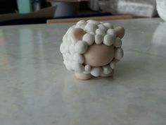 a small toy sheep sitting on top of a table