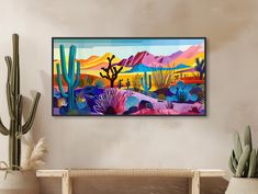 a painting on the wall above a couch in a room with cacti and cactus