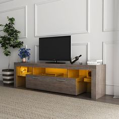 a living room with white walls and a television on top of a wooden entertainment center