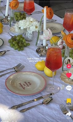 the table is set with plates, silverware, and wine glasses for an elegant celebration