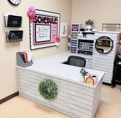 an office decorated in pink, white and black with lots of decor on the walls