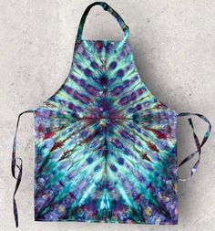 a tie dye apron hanging on a wall