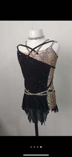 a mannequin wearing a black top with sequins on it