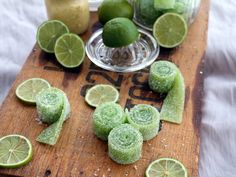 limes and sugar on a wooden cutting board