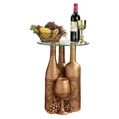 two vases and a wine bottle on a glass table with grapes, pineapples, and fruit