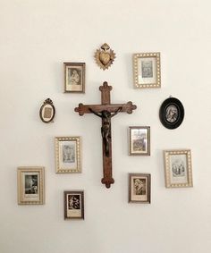 a cross is surrounded by many framed photos