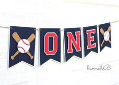 a banner with baseballs and bats on it is hanging from the side of a wall