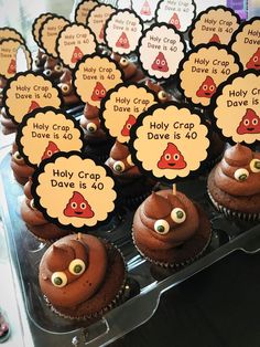 cupcakes with chocolate frosting decorated like angry birds are on display at a birthday party