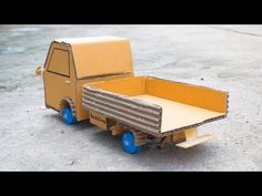 a cardboard box truck with wheels on the ground