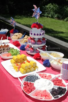 a table topped with lots of different types of foods and desserts next to a window