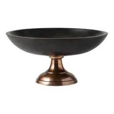 a black bowl sitting on top of a metal stand