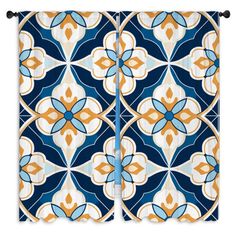 two blue and orange patterned curtains hanging on a wall