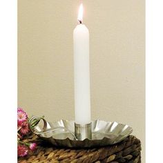 a white candle sitting on top of a metal tray