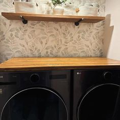 a washer and dryer sitting next to each other in front of a wall