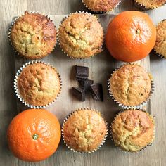 muffins and an orange on a wooden table