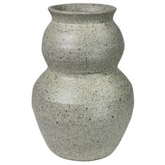 a large gray vase sitting on top of a white table