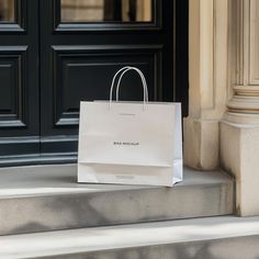 a white shopping bag sitting on the steps