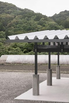 an outdoor covered area with trees in the background