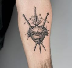 a black and white tattoo with two swords in the center, surrounded by other items