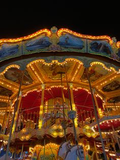 a merry go round is lit up at night