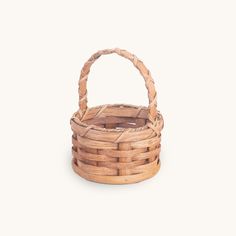 a small basket made out of wicker on a white background