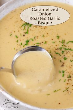 a white bowl filled with soup and topped with a spoon