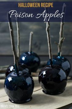 three blue apples sitting on top of a table with sticks sticking out of the tops