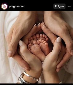 two people holding their hands in the shape of a baby's foot