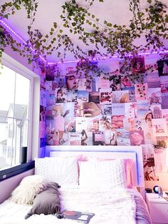 a bedroom decorated in pink and white with purple lights on the ceiling, plants growing over the bed