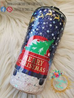 a christmas themed tumbler sitting on top of a fur rug