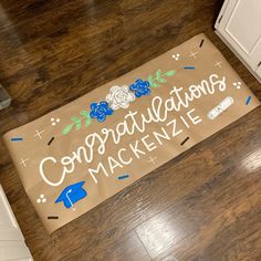 a door mat that says congratulations mackenzie on the floor in front of an oven