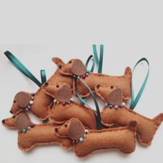 four felt dachshunds with beads on them