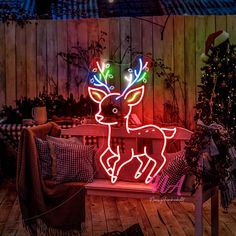 a lighted deer sitting on top of a wooden bench