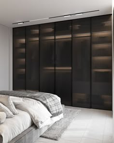 a large bed sitting in the middle of a bedroom next to a tall black closet