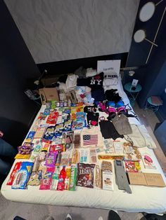 an unmade bed with many items on it