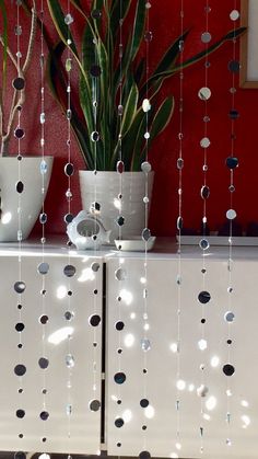 a white cabinet sitting next to a potted plant