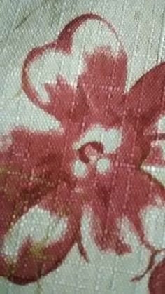 an octopus painted on the side of a bed sheet with red and white paint splattered all over it