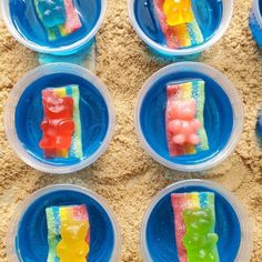 six plastic plates with gummy bears on them in the shape of rainbows and ice cream