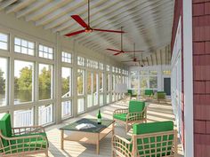 an artist's rendering of a screened porch with green furniture and ceiling fans, overlooking the water