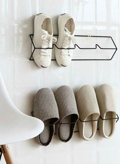 there are four pairs of shoes hanging on the wall