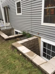 an outside view of a house with steps leading up to the front door and windows